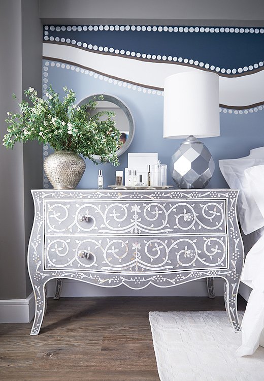 Short on bedroom storage? Flank the bed with dressers that double as nightstands, as Andrew does in Kim’s bedroom with a pair of bone-inlay chests.
