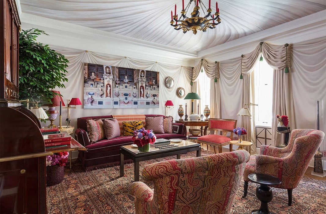 Alexa Hampton dubbed her room the “Olympia Folly.” The designer’s appreciation of neoclassicism is on full display with trompe l’oeil tented walls, photographs of Greek architecture, and a tailored compilation of antiques and patterns ranging from paisley to Le Tigre. 
