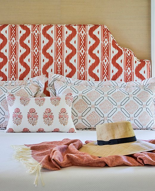 In the guest room, pops of persimmon and layers of pattern add an element of playfulness to the tropical home. 
