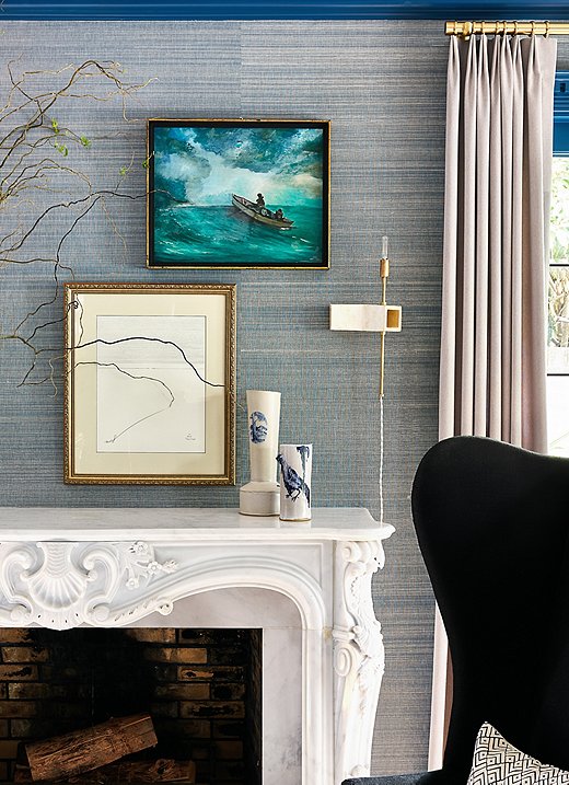 Lynn took a curatorial approach when styling the mantel. The abstract art mixes beautifully with the more traditional seascape. The ceramic vases also play nicely off the handcrafted sconces by ceramicist John Sheppard. Moments like these really bring the design to life.
 
