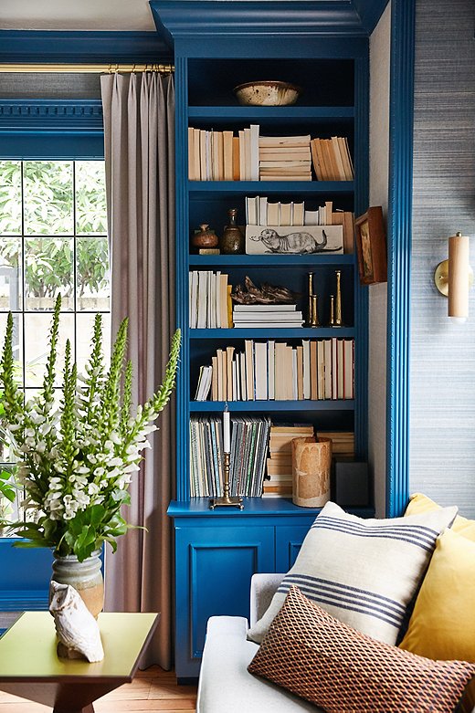 Lynn let the blue color palette do the work in the formal living room. She turned books around to let the worn color of the pages work symbiotically with other natural elements. She relied on the pillows to bring out the room’s complementary colors.
