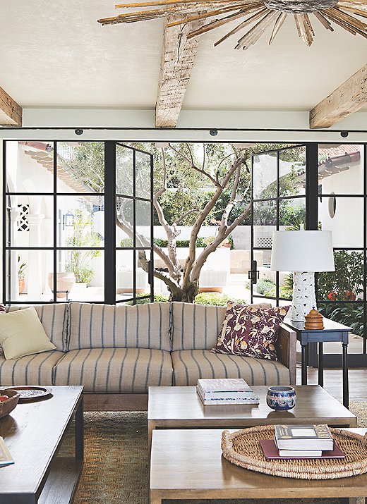 The sofa in the living area, which opens onto the courtyard on one side and looks out onto the Pacific on the other, is upholstered in fabric from Chris Barrett Textiles.
