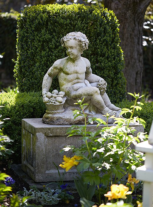 Another view at Historic Botherum: A stone sculpture backed by boxwoods.
