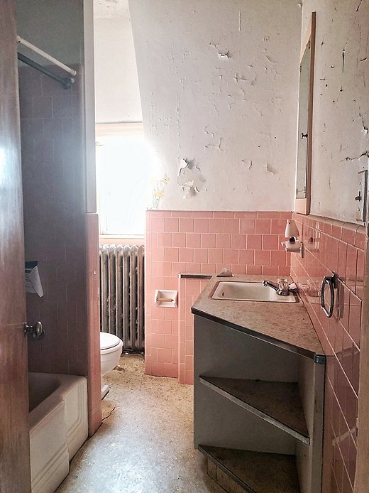 Pink tile might be having a moment, but Carli wasn’t a fan. She attacked this bathroom and removed the linoleum, counter, and all the features. She left the tile and boarded over it.
