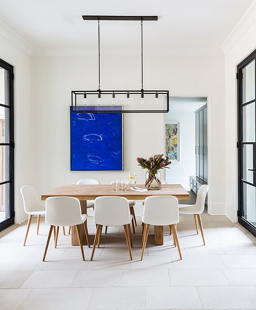 The dining area off the kitchen is simplicity at its best. The steel-framed windows and doors speak to a refined elegance of clean lines and subtle power.
