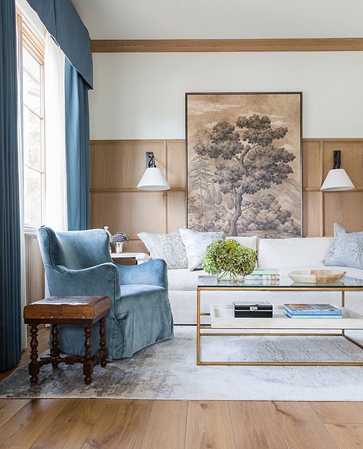 “This is one of my favorite room ever photographed,” Marie says of the quiet sitting area adjacent to the master suite. “I love the richness of the blue and the comfort of the room.” Marie enlisted the help of Gracie Studio’s artisans to create the one-of-a-kind art behind the sofa. “I asked if they could customize this piece I had envisioned in my head. I wanted to do it in a huge scale that drops down behind the sofa and anchors the space. It becomes a focal point that adds textural beauty to a nature-inspired palette.”

