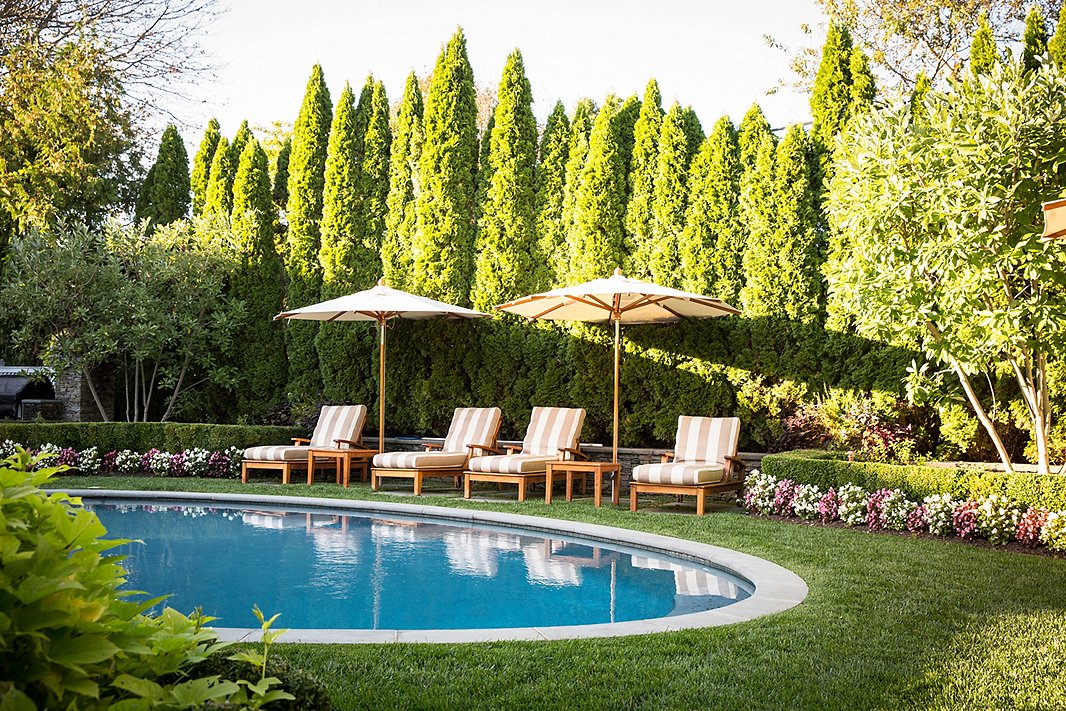 Surrounded by tall trees and manicured hedges, this poolside feels like a true oasis. Photo by Lesley Unruh. 
