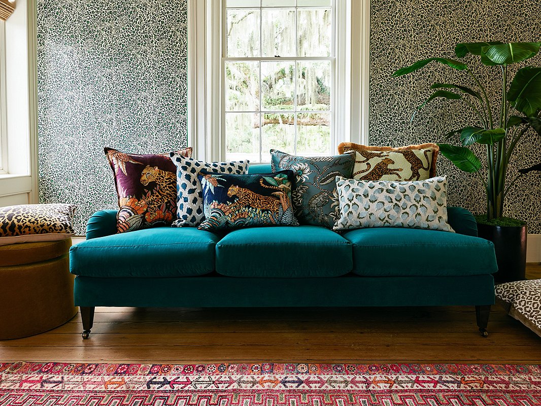 The small scale of our exclusive Pounce Wallpaper in Khaki balances the larger prints of the pillows (from left: Cheetah Kings in Plum; Trinka Pillow in Navy; Cheetah Kings Lumbar in Tanzanite Velvet; Floral Pheasant Pillow in Blue; Cheetah Kings in Stone Velvet; Trinka Lumbar in Spa Green). Find the sofa here.
