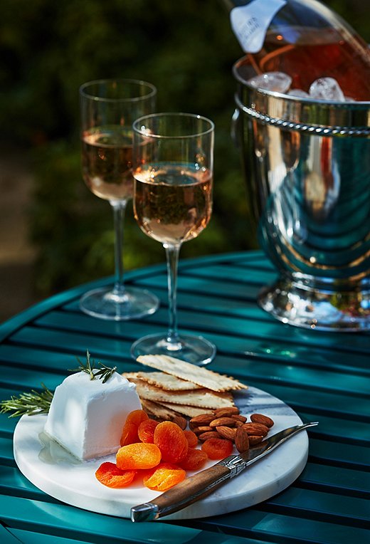 Cheese, crackers, dried fruit, nuts: When it comes to outdoor entertaining, we think simpler is better. A stylish wine bucket means you won’t have to dash indoors for refills.
