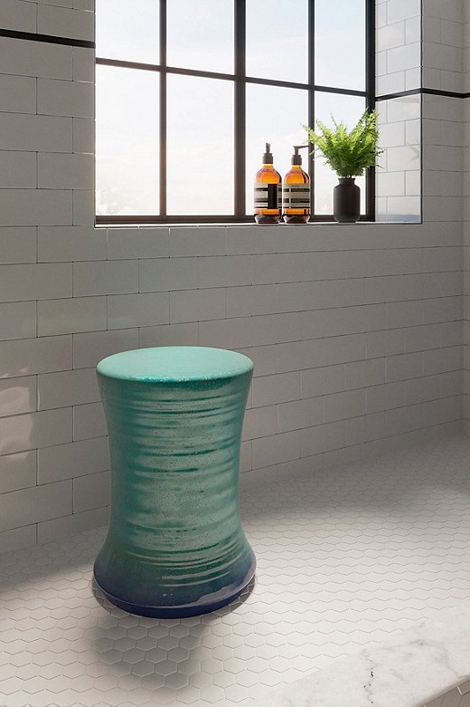 Becca extended the green cabinetry into the shower with a jaunty garden stool.
