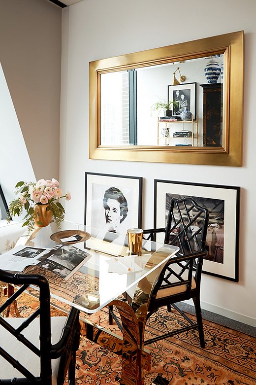 Opposite the secretary, the oversize Duke Mirror from Ralph Lauren Home hangs above prints from the magazine’s vast photo archives. The portrait of Babe Paley (at left)—who Stellene calls one of the “quintessential modern swans”—is by famed photographer Richard Avedon. 
