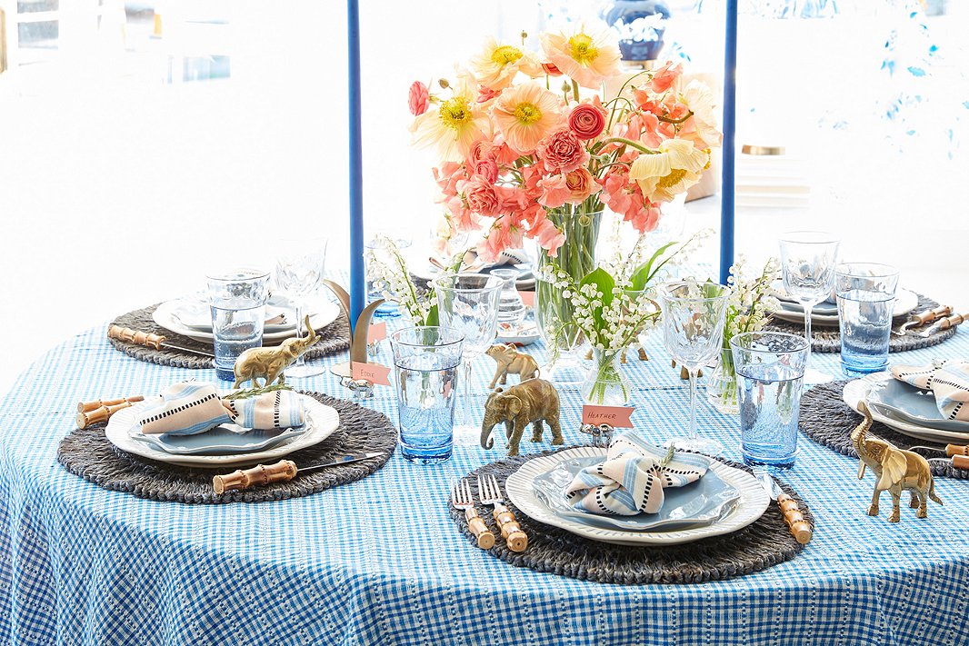 Jane’s signature table always includes extra-tall candles from Creative Candles, which are seen here amid Juliska’s Loop place mats, Sitio Stripe dinner plates, Berry & Thread salad plates, Carine tumblers, and Vienne white-wine glasses. 
