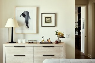 The dark hardware against the blonde wood of the dresser gives the piece a more sophisticated feel. “Adding black to the most neutral space can add a touch of elegance,” says Becca.
