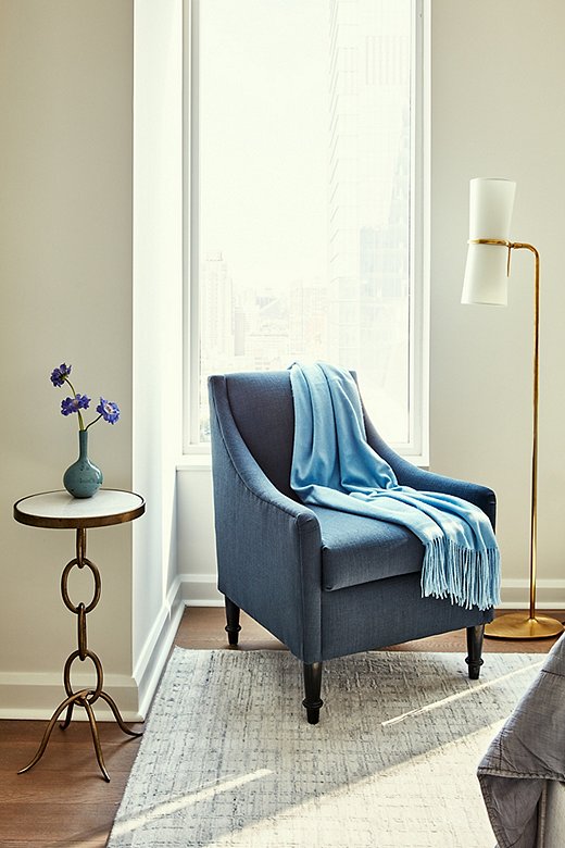 Never one to give up an opportunity to maximize seating options, Becca chose a chair with a small silhouette that fits just so in the corner of the master bedroom. She selected blue to keep the color palette cohesive throughout the room.
