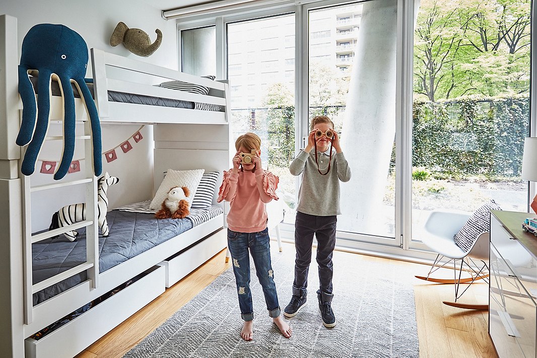 Elin and Nils hang out in their shared room, which looks out onto their building’s private garden.
