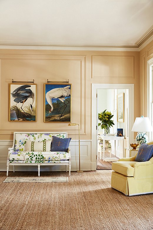 Two Audubon reproductions are given place of honor above a floral-print settee. The natural-fiber rug reinforces the back-to-nature motif.
