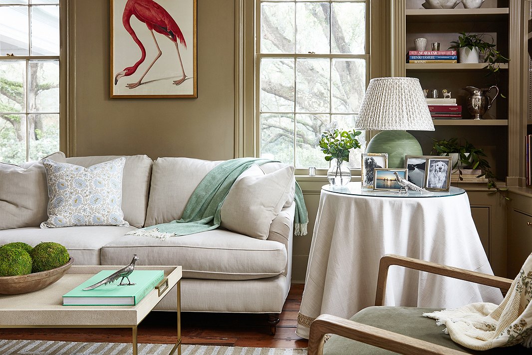 Audubon’s American flamingo print brings a pop of color to the room’s otherwise quiet palette. Find the sofa here.
