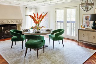 The rich color and modern silhouette of the Ella Accent Chairs in Emerald Velvet provide a dynamic contrast to the serenity of the neutral traditional rug. The chairs’ curves also complement the straight lines of the Lexi Sideboard.
