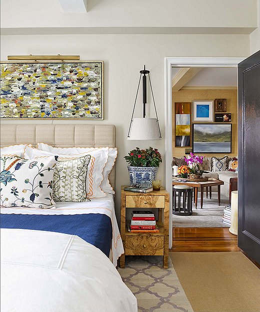 Philip and Mark maximized space in the bedroom by implementing storage under the bed and using bedside tables with drawers. Instead of having lamps take up room on the nightstands, the bed is framed by twin sconces. 
