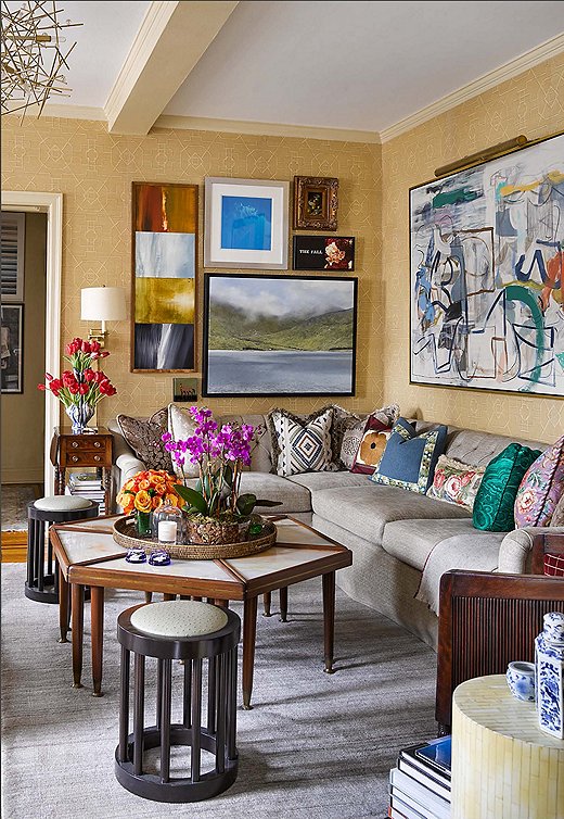 The custom sofa and sectional in the living room are dressed in neutral fabrics to accommodate a host of mix-and-match pillows, which include embroidered vintage finds along with designs from Bunny Williams Home and Brunschwig & Fils.
