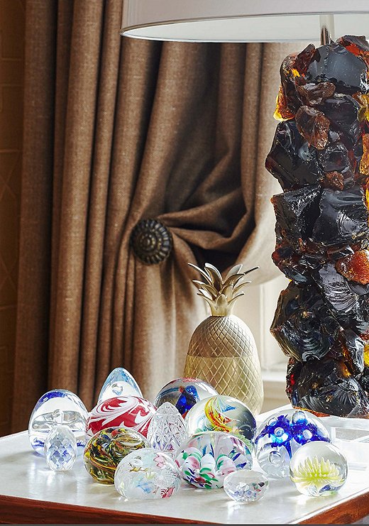 An assortment of Murano glass paperweights, which Philip has been accumulating since he was a child, is one of the many colorful collections that live within the apartment. 
