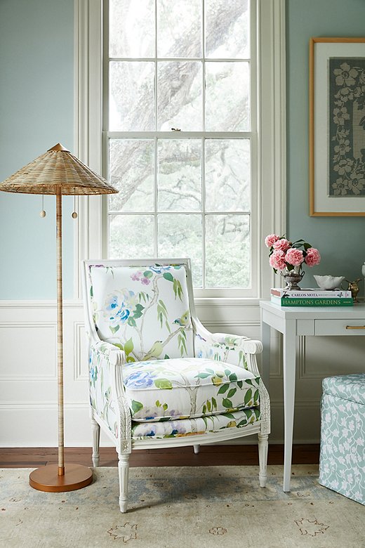 The print of the James accent chair’s upholstery is both larger in scale and more airy than floral prints of a generation ago. The Terrace floor lamp, with its rattan shade, counterbalances the chair’s refined frame with a touch of tropical texture.
