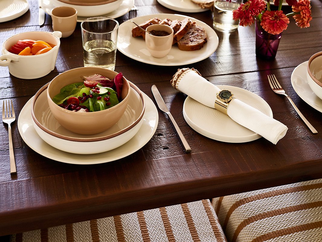 The greens and reds of guacamole and chili salsa will look even more appetizing set against tableware with an elegant yet earthy vibe. Shown above: Shell Bisque Dinner Plate in White; Unique Bowl in Latte (holding salad); Knotted Edge Napkin in White/Brown. Photo by Frank Francis.

