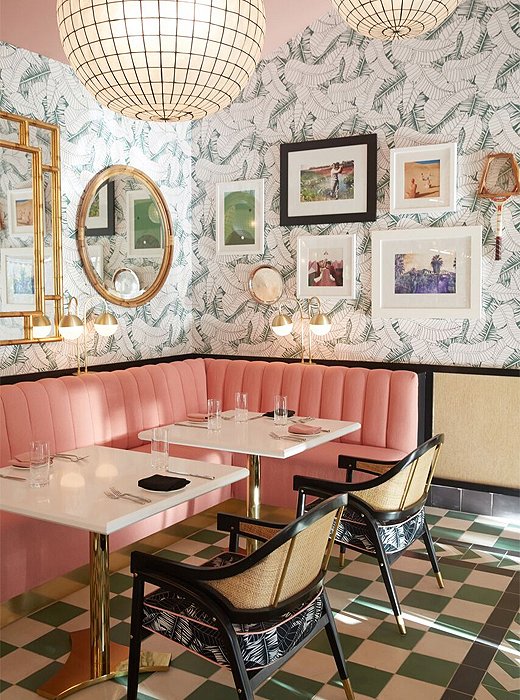 Pink velvet banquettes sit against Martyn’s banana-leaf wallpaper.
