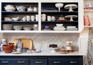 Virginia went for a classic palette of blue and white in the kitchen. She used open shelving to display her sets of tableware.
