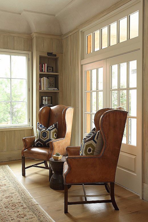 Wingback chairs in a saddle leather with funky pillows add a touch of texture to the home. In a space without a lot of colors, texture is key to adding depth and variety.
 
