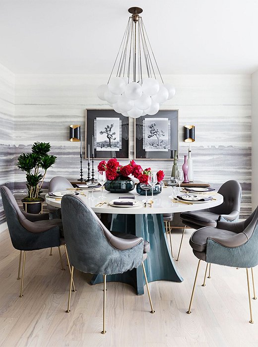 Statement lighting and scenes of Joshua Tree lend life to the dining area. A nonporous table and leather chairs can be easily wiped down in the event of a spill. 
