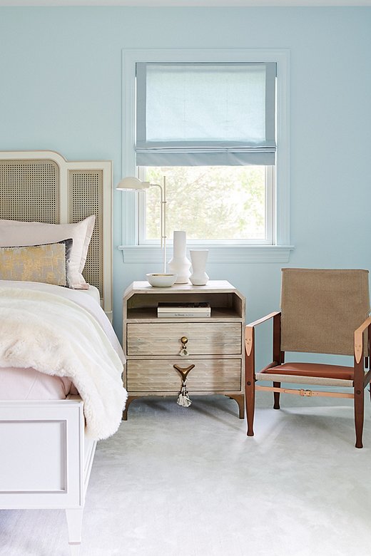 The guest room was designed for the grandmother of one of the clients. The caned bed exudes a sweet, traditional feel, while the whimsical nightstand and the safari chair are classic in a more modern sense.
