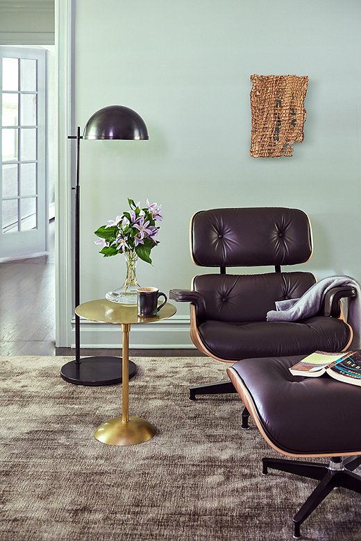 Brass elements such as the side table warm the space. Tina used custom rugs by Stark Carpet throughout the home.
