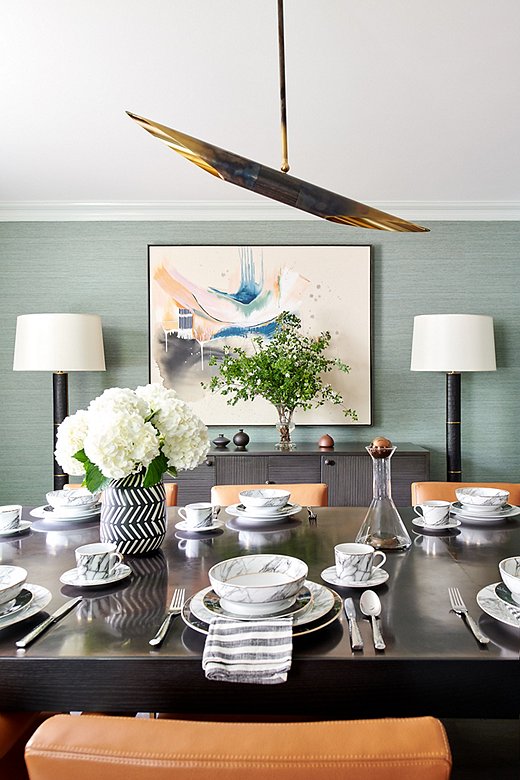 “We wanted to incorporate some formality in the dining room,” says Tina. She paired a custom table with a textured mahogany sideboard.
 
