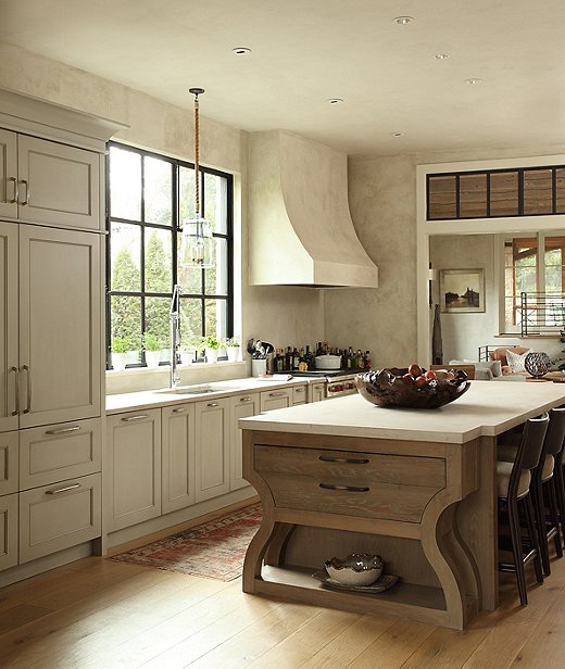 Custom cabinetry from Atlanta-based Karpaty Cabinets is a total showstopper in the kitchen. The corset cabinet at the end of the island stores the family’s everyday tableware.
