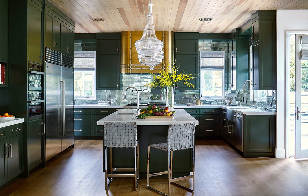 Glass subway tiles in the kitchen reflect the clients’ love of New York City. The hood was a special addition by Adam. “I wanted it to look like an old metal truck,” he says. 
