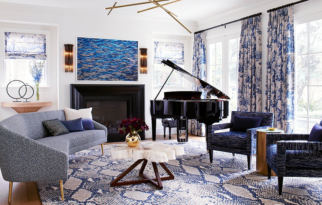 Adam wanted to do a traditional blue-and-white color scheme in the house, but he wanted to do it his way. The wild mix of pattern and color in the space plays on his love of eclecticism and vibrancy while remaining rooted in a traditional palette. The baby grand piano adds a classic note to the atmosphere. 

