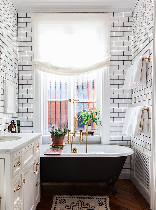 In the home of author and cooking-school founder Alison Cayne, a black-painted claw-foot tub brings a moment of drama to an otherwise all-white space. Photo by Lesley Unruh.
