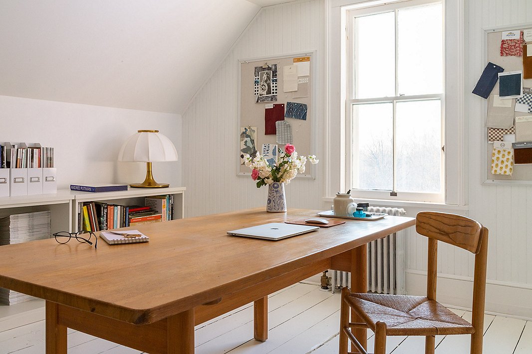 The formerly unfinished attic is now the Richters’ home office. White paint and pale wood furnishings have transformed it into a bright, inviting space.
