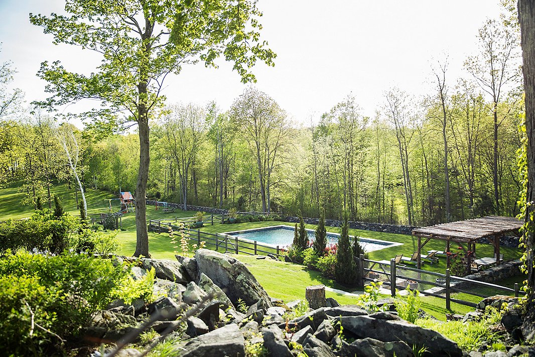 Set farther back from the house, this pool features a rustic wood gazebo and a coordinating fence, taking full advantage of the property’s vast acreage. Photo by Lesley Unruh.
