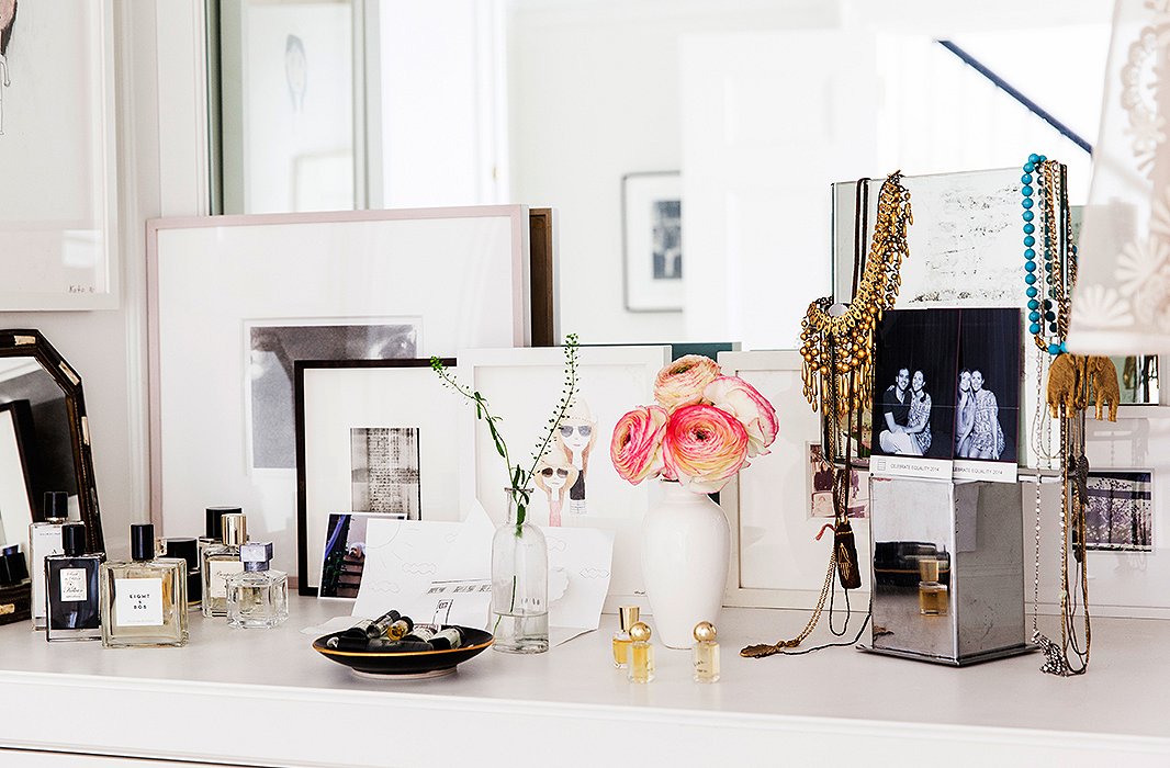 The vanity is as curated as the rest of the house, with photographs of friends and a three-dimensional artwork by her daughter.
