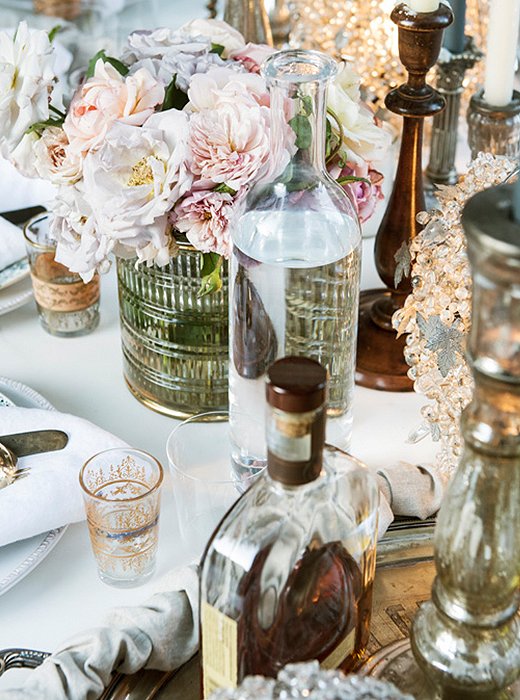 Roses from the garden are placed in low gold-embellished glass vessels so that guests can chat without obstruction. Amy also loves using magnolia leaves or olive branches to dress a table during the cold-weather months.
