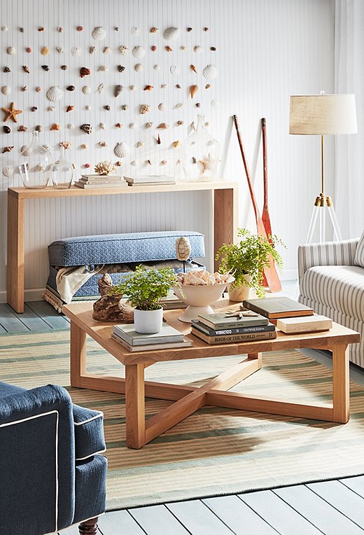 Coffee tables are a collector’s best friend. Use them like mini museums to show off all your pieces. Here, seashells take center stage. They’re tucked nicely into a decorative bowl.
