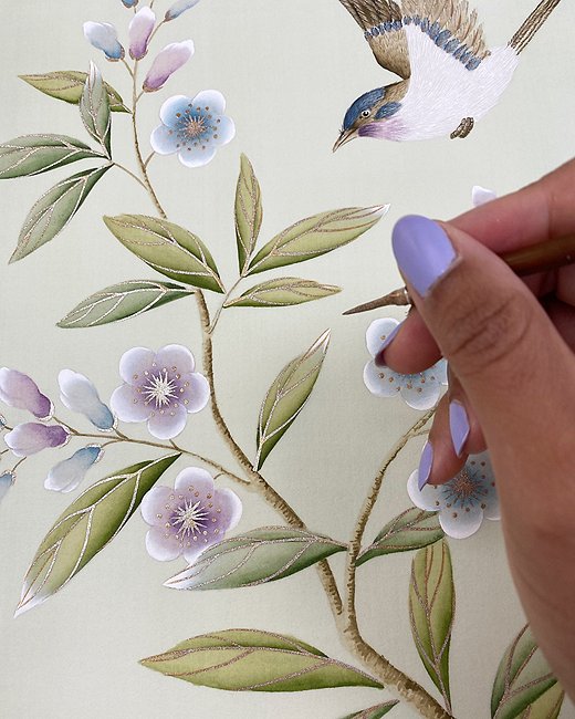 Chinoiserie really shines in the detail work. Diane uses a variety of brushes to highlight certain parts of the design. Here, she is using a small brush tip to add gold accents to the flowers and leaves.
