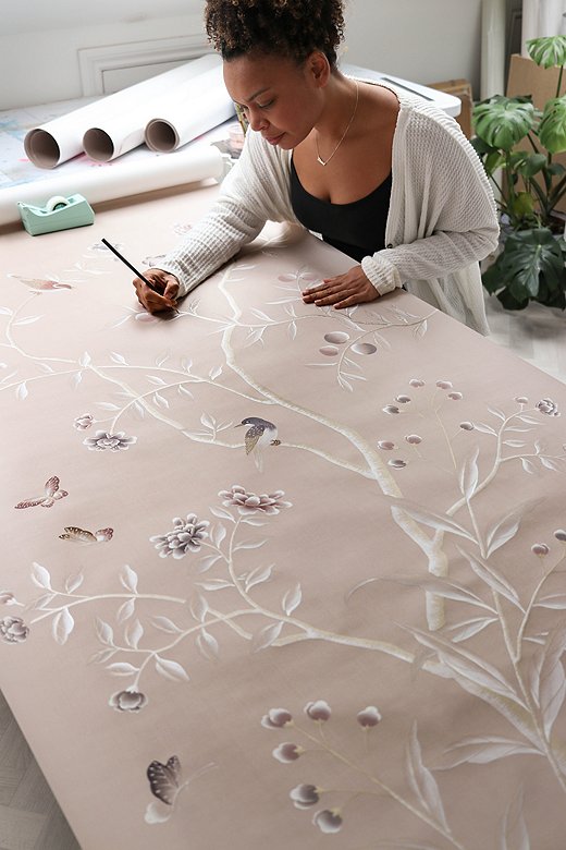 Diane in her studio painting a wallpaper panel. Each panel takes her one week from start to finish.
