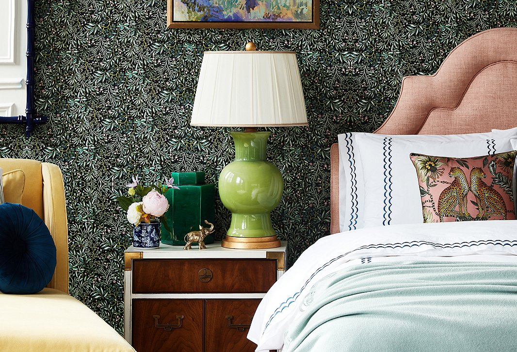 The darker hues and dense motif of the Vikki Chu Black Forest Wallpaper tie together the disparate room elements in a way that plain pale walls never could. Furnishings above include Roslin Chaise in Canary Velvet and Eileen Round Pillow in Indigo.
