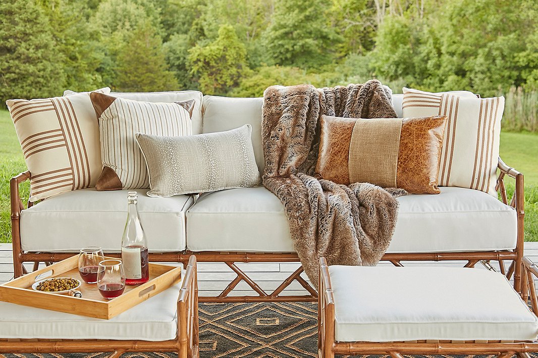 Faux-fur throws, leather pillows, and animal prints show how luxurious natural influences can be. Items shown above include the Further pillow (far left and far right), the Evie lumbar pillow (center), the Mia Faux-Fur Throw in timber wolf, and on top of the throw, the Abby lumbar pillow.
