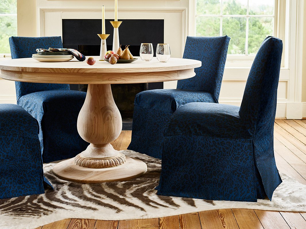 A nature-inspired palette doesn’t have to mean all earth tones. The deep blues of the evening sky add organic drama to a room. Case in point: these Owen Slipcover Chairs. The unfinished wood of the Charlotte Round Dining Table both contrasts with and complements its refined shape. Find the marble-and-steel candlesticks here.
