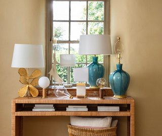 Table lamps are among the most versatile light fixtures out there. Think of them as objets or pieces of art. Lamps shown on the table above, from left: Jane Petal Table Lamp, Knuckle Matte Table Lamp in Oak/Brass, Jillian Table Lamp, Knuckle Clear Table Lamp in Walnut/Brass, and Gisele Drip Table Lamp.
