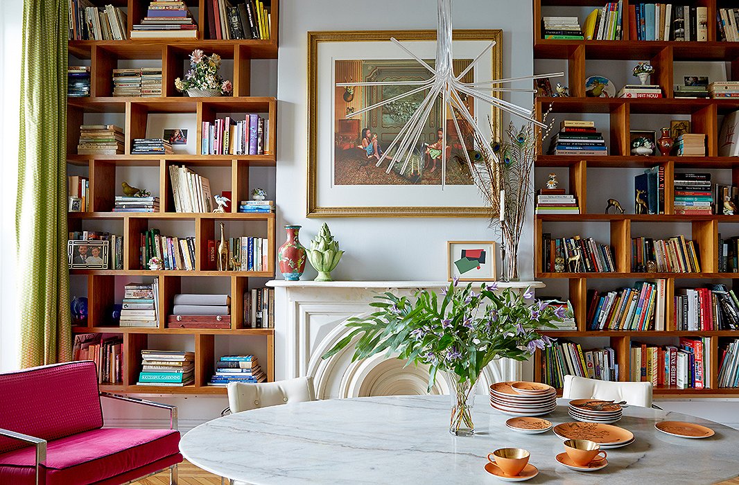 Ever a fan of juxtaposition, Fawn loves how the contemporary light fixture sprouts “like a flower” from the ceilings’s decorative molding. The custom-built shelving provides much-needed storage in the home, which was built more than a century ago. New York artist and friend Meghan Boody gifted the piece above the mantel.

